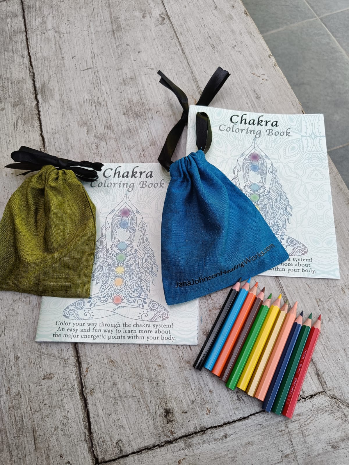 coloring book with a green bag and blue bag and 12 small coloring pencils